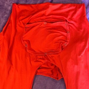 Long sleeve romper with bootie panel.